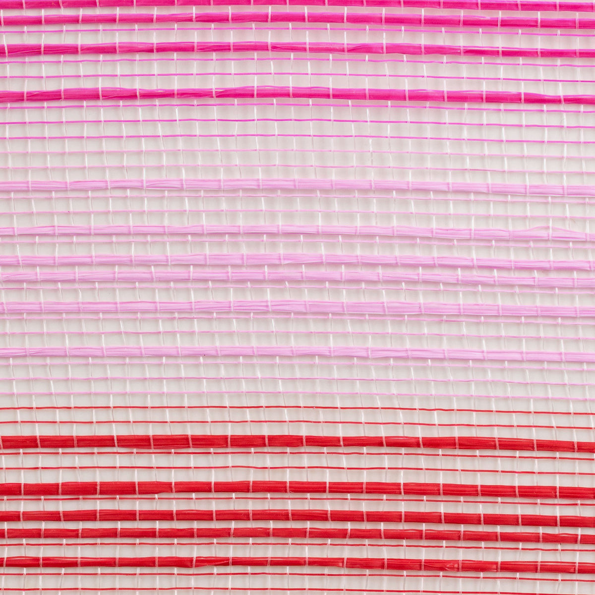 Close up of pink, hot pink and red vertical wide stripe deco mesh weave MPN RE138566