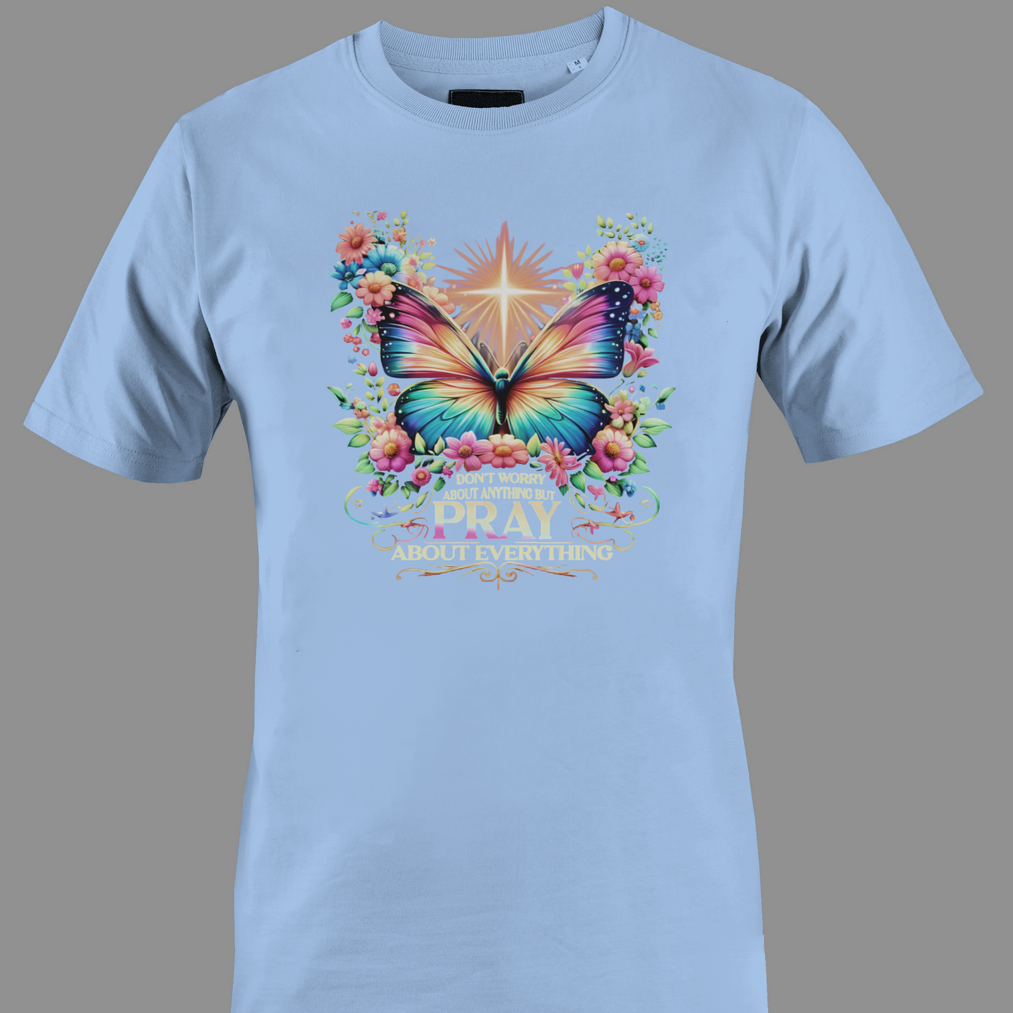 Light blue t-shirt with a colorful butterfly and florals with text Pray