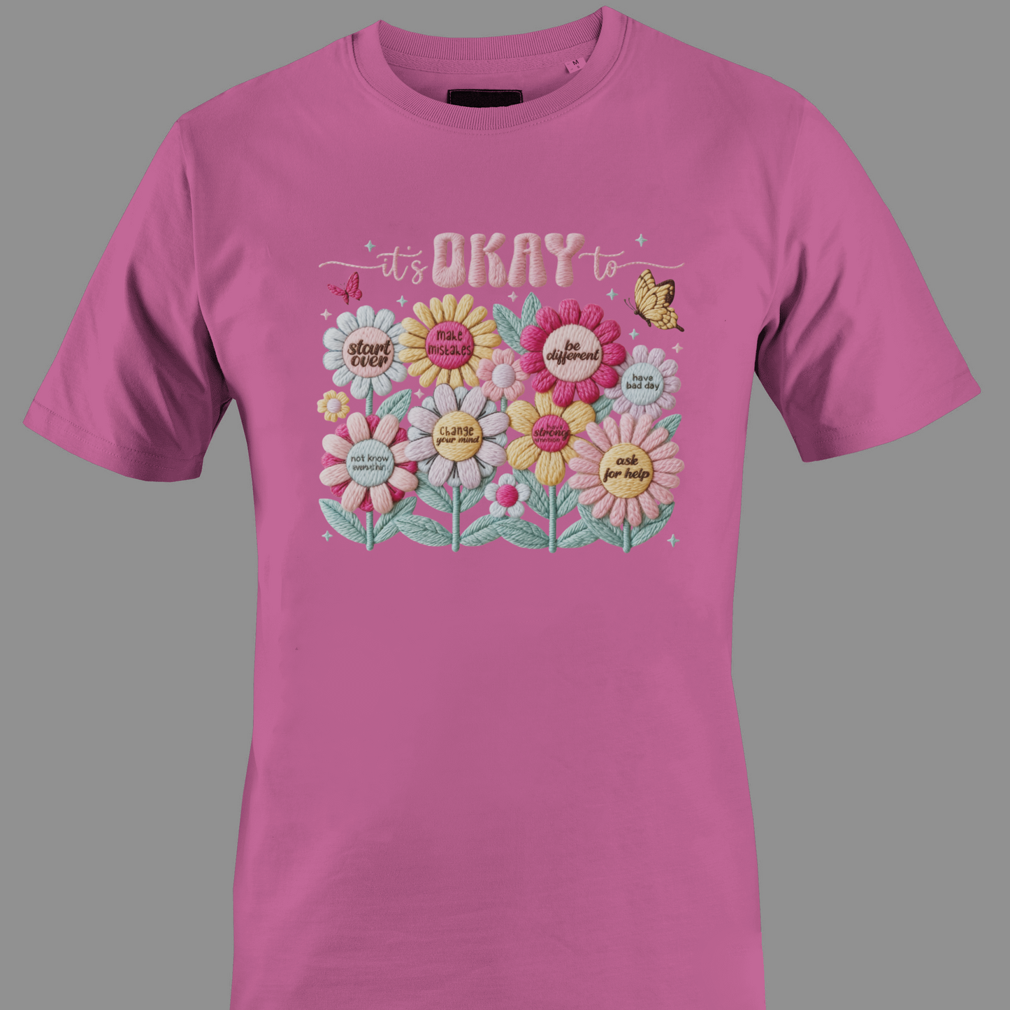 Pink t-shirt with floral design and text It's ok to