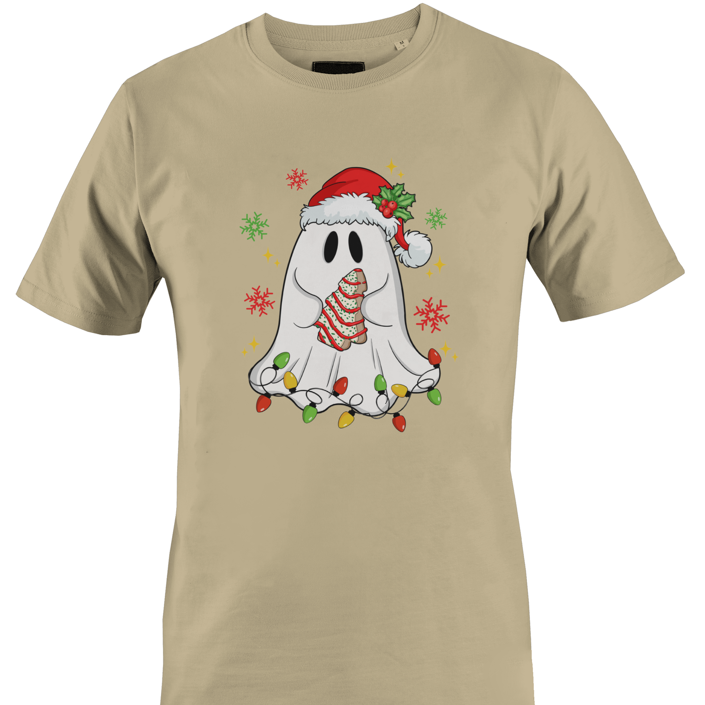 A tan short-sleeve crewneck t-shirt featuring a festive graphic of a cute white ghost wearing a red Santa hat and a striped red-and-white scarf, surrounded by colorful Christmas lights and snowflakes holding a cookie by Monkey's Creations.