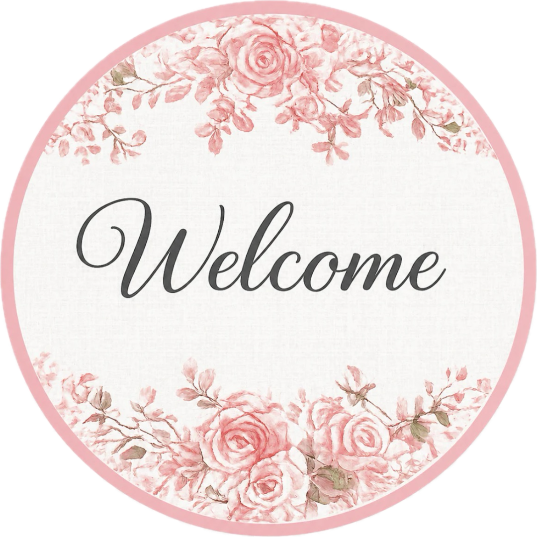Round metal wreath sign by Monkey's Creations featuring a white background with black "welcome" text and light pink chinoiserie style roses and a border