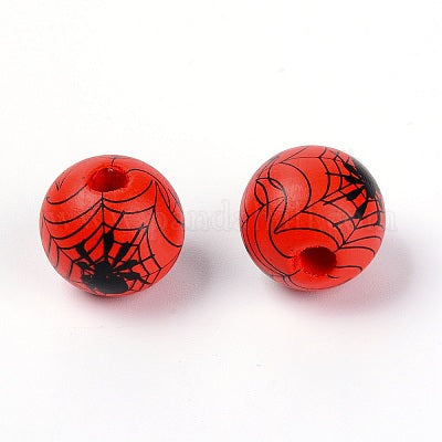 Painted orange wooden beads with black cobwebs and spiders for crafting and wreath making.