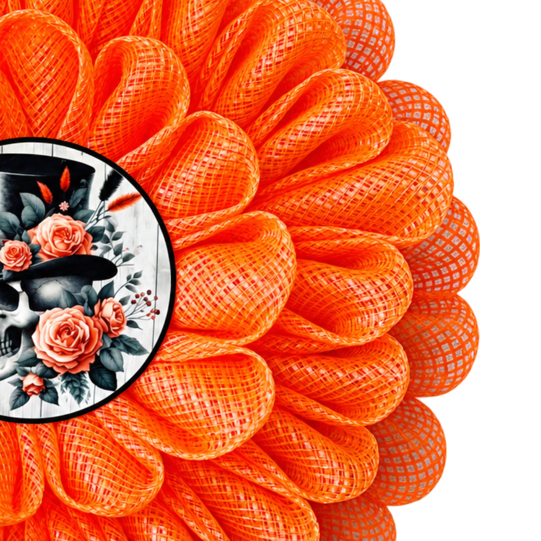 An orange deco mesh 3D flower wreath with a skull and roses center for Halloween by Monkey's Creations.