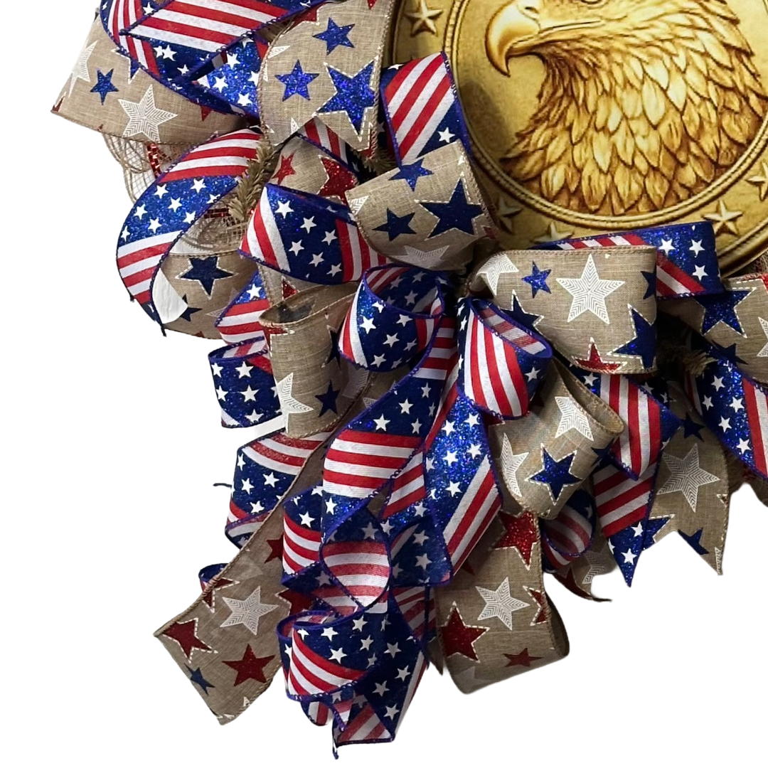 Deco mesh wreath with a golden eagle wreath sign surrounded by American flags themed ribbon