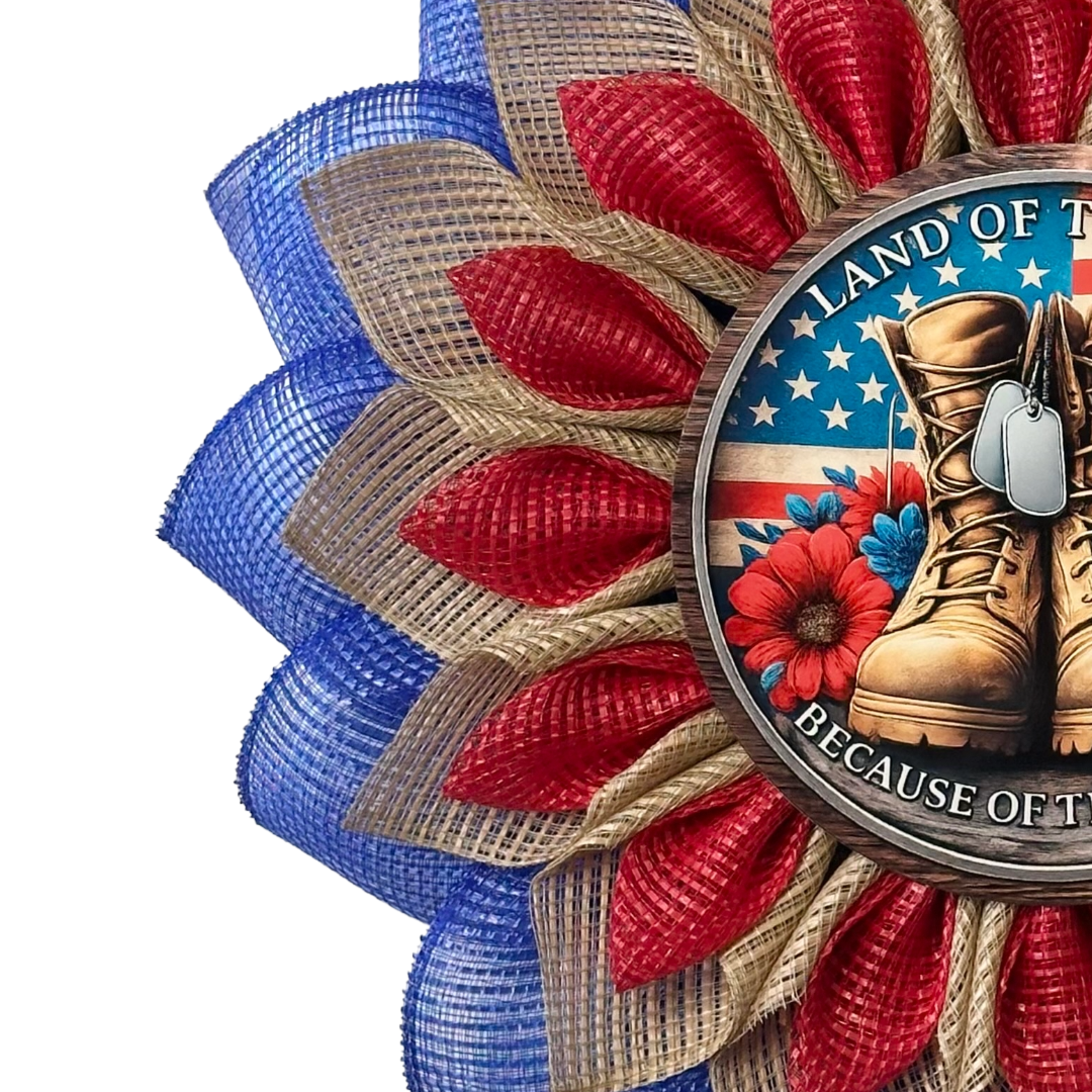 Red blue and natural flower wreath with a flag and veteran themed metal sign center with text "land of the free because of the brave" designed by Monkey's Creations