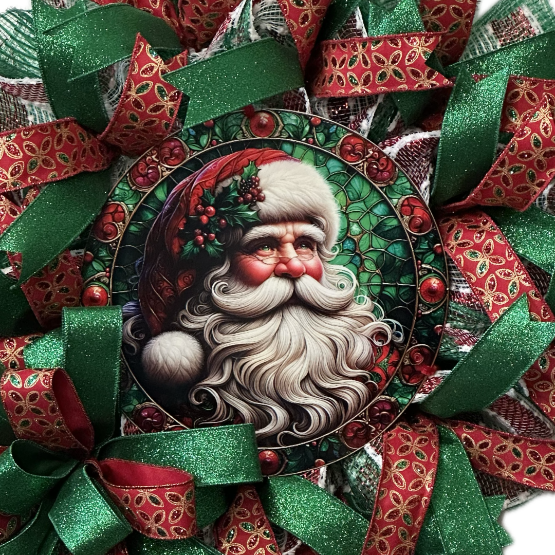 A red green and gold deco mesh and ribbon Christmas wreath with a vintage Santa Claus metal wreath sign center by Monkey's Creations.