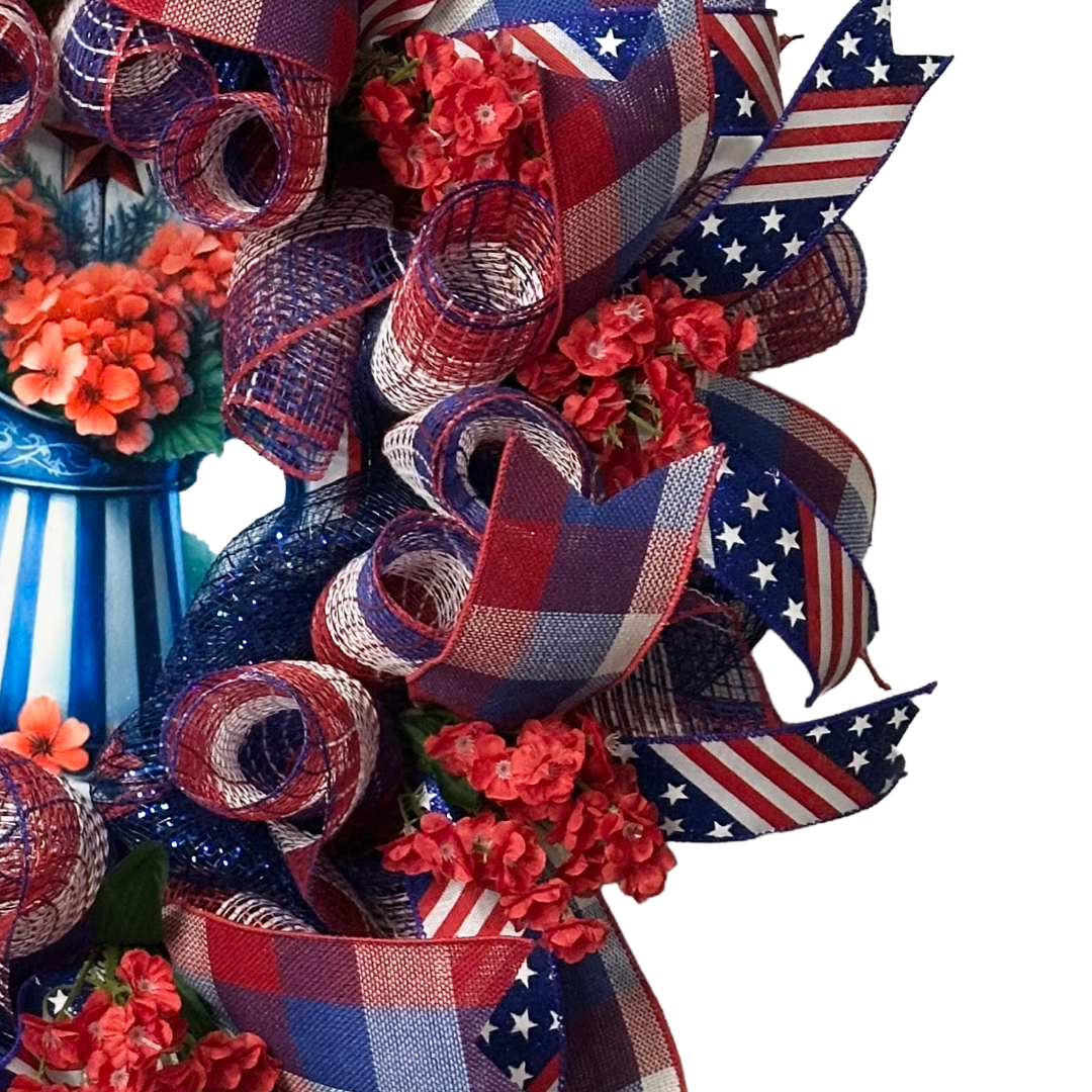 Deco mesh and ribbon wreath with red, white, and blue ribbons and flowers, featuring a 'Sweet Land of Liberty' by Monkey's Creations.