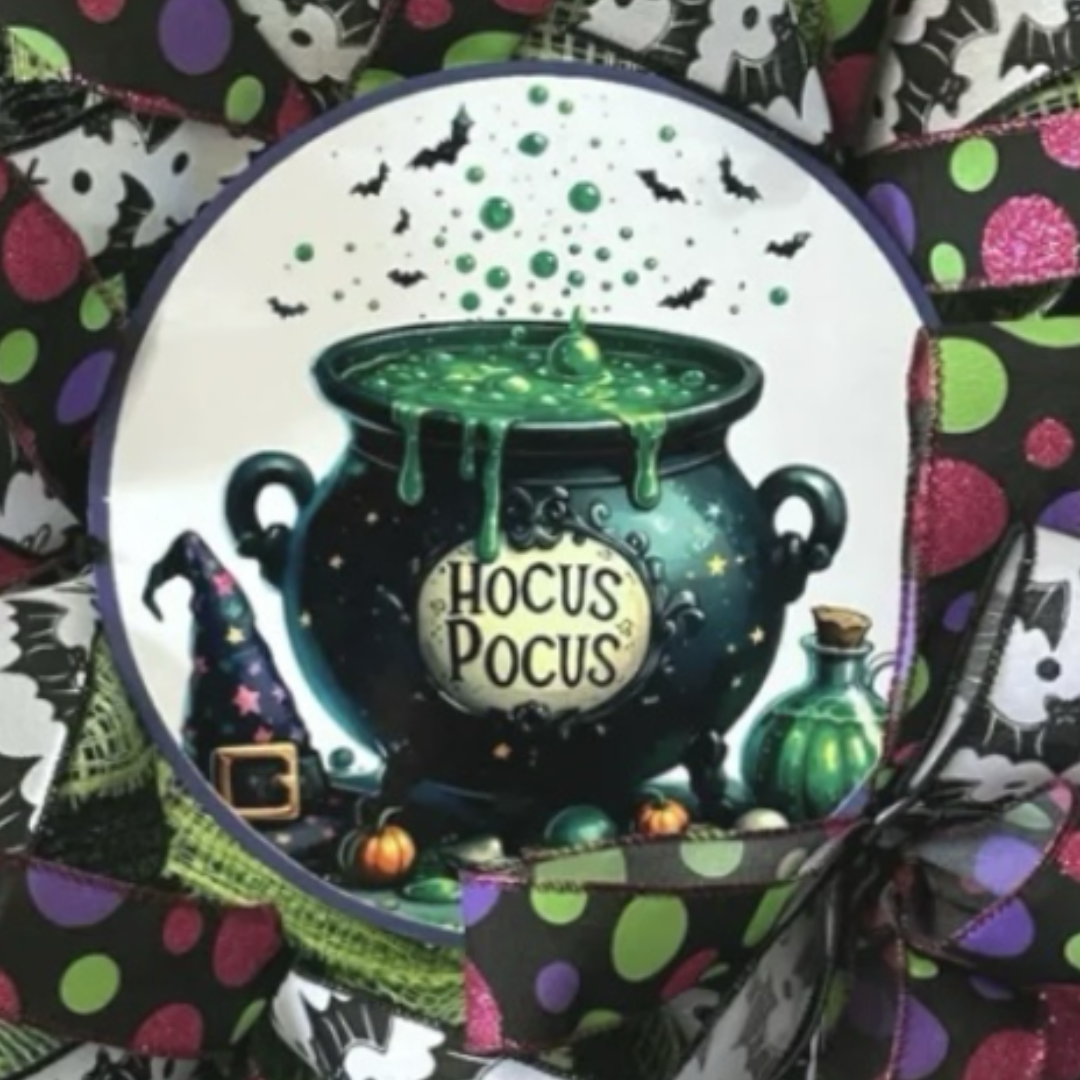multicolor polka dot and black bat ribbon hocus pocus cauldron halloween wreath, focus on wreath sign