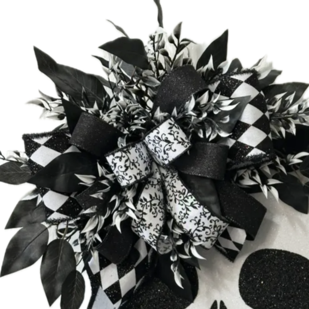 halloween skeleton skull with black and white ribbon and foliage, focus on the ribbon
