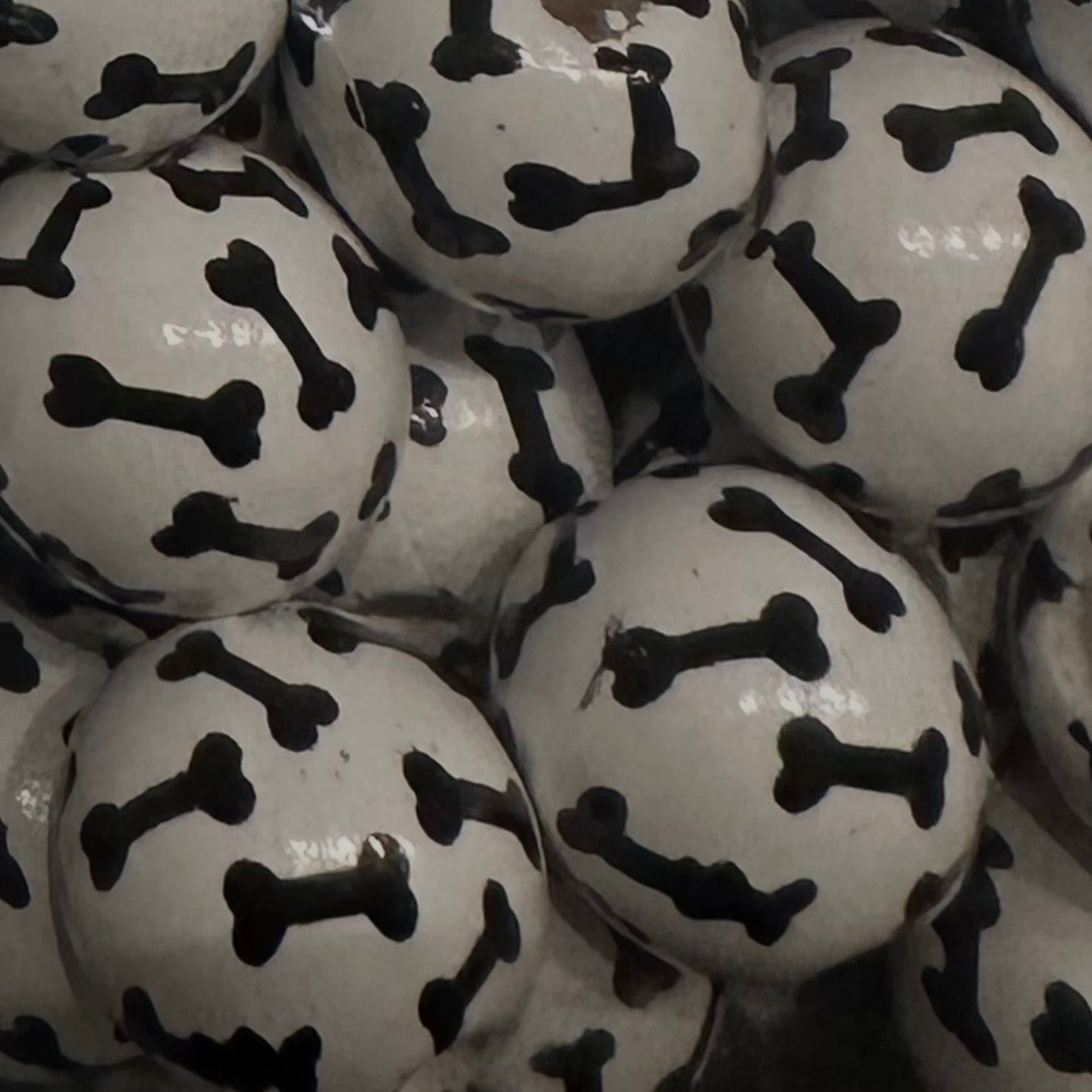 white wooden beads with black dog bones