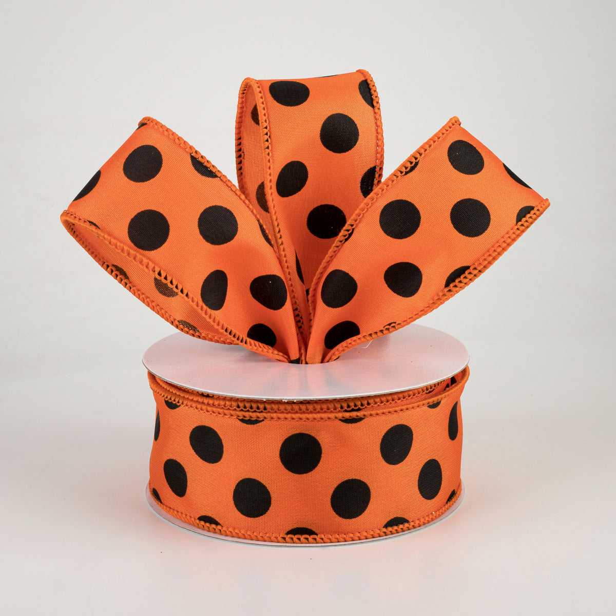 1.5" by 10 yard roll of orange with black polka dots satin finish wired ribbon for Halloween crafts and wreaths carried by Monkey's Creations - MPN - RG1586YF.