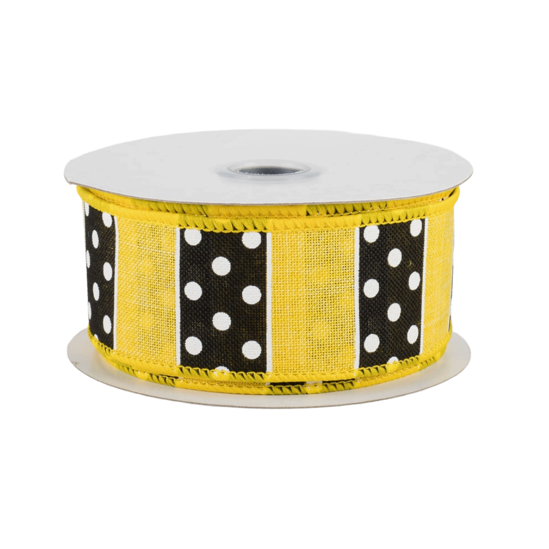 Roll of yellow ribbon with black and white polka dot pattern 