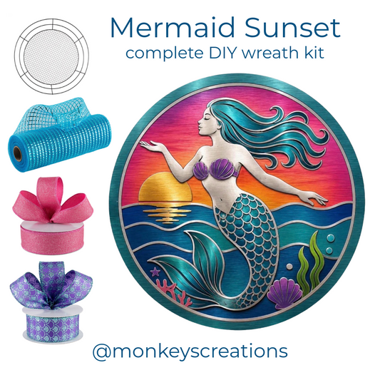 Mermaid sunset DIY wreath kit with a roll of turquoise blue deco mesh, a roll of pink glittery ribbon, a roll of purple and aqua  ribbon, a wreaths of joy work form and a round mermaid metal wreath sign by Monkey's Creations. 