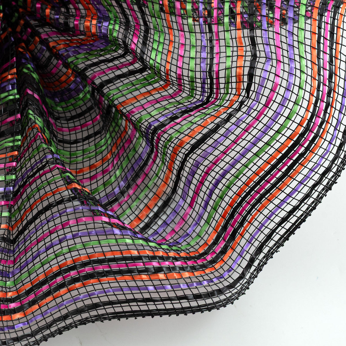 Close up of orange, black, purple, lime green and lavender vertical wide stripe striation deco mesh weave carried by Monkey's Creations. MPN - RE1369YM.