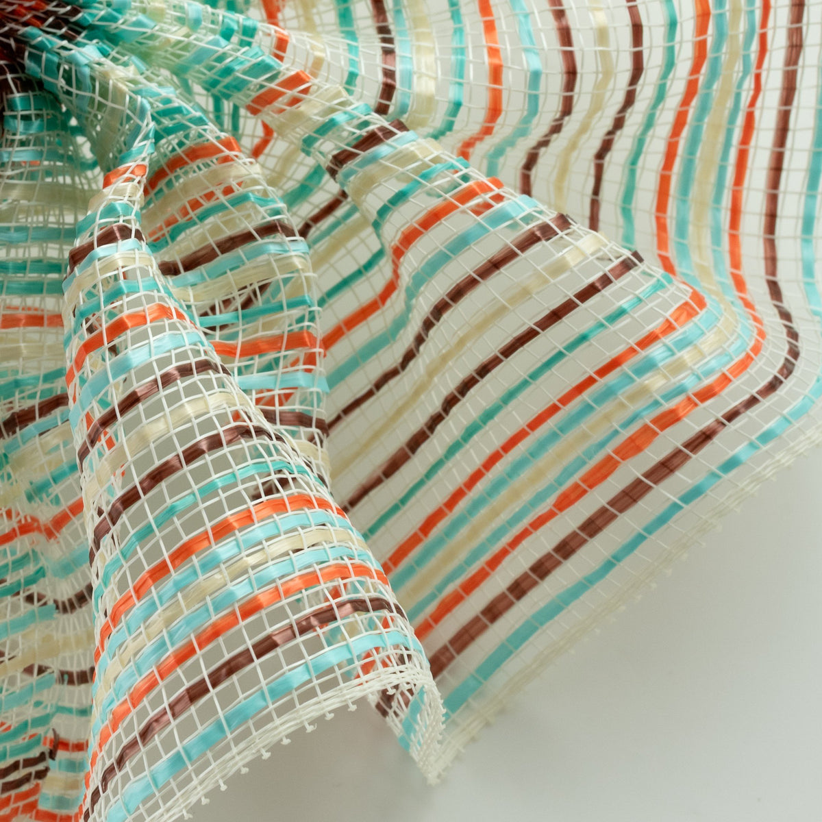 Close up of teal, turquoise, brown, orange and creme vertical wide stripe striation deco mesh weave carried by Monkey's Creations. MPN - RE1369YF.