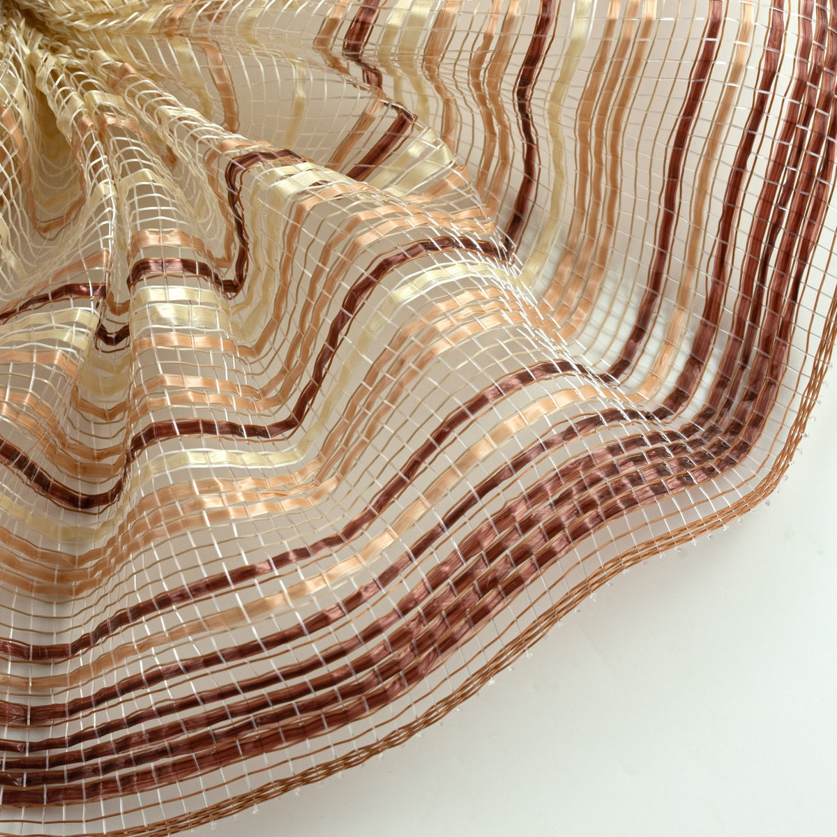 Close up of ombre style chocolate brown, caramel and ivory vertical wide stripe deco mesh weave