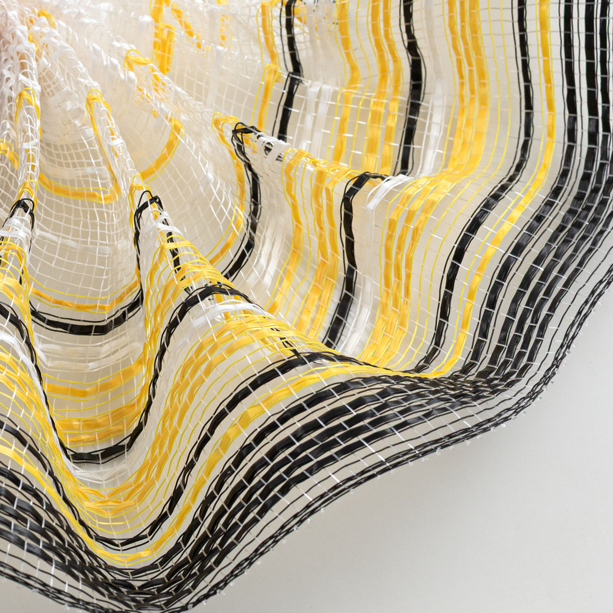 Close up of ombre black, white and yellow vertical wide stripe weave carried by Monkey's Creations MPN: RE13861T
