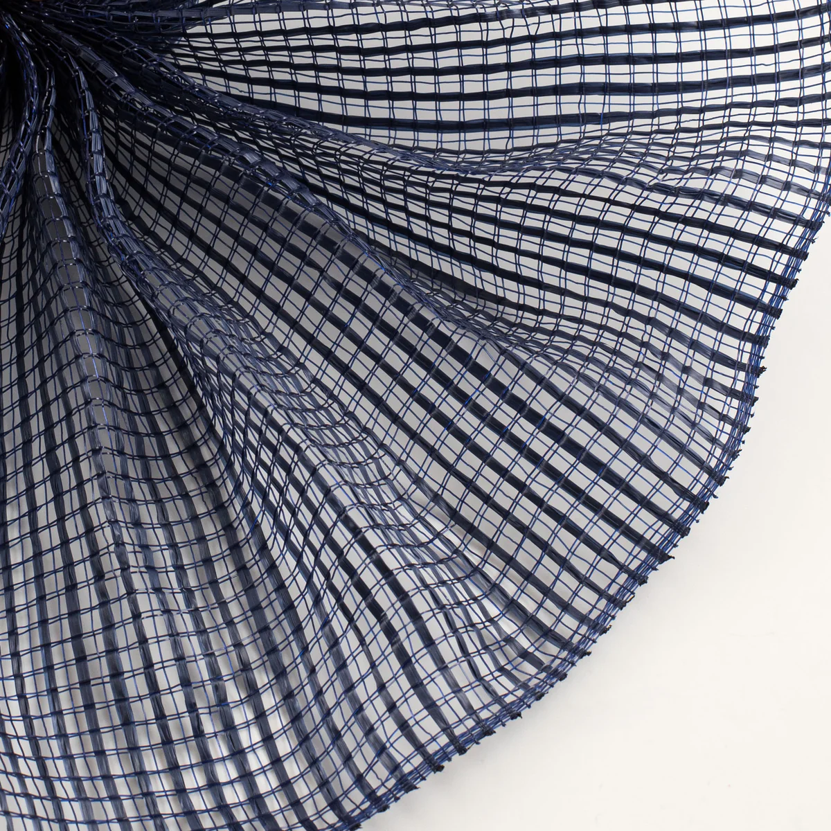 Close-up of a textured navy blue horizontal wide stripe deco mesh weave fanned