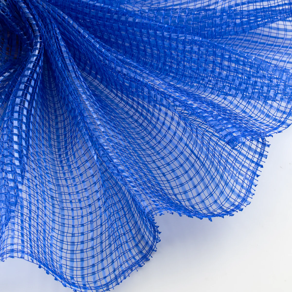 Close-up of a textured royal blue horizontal wide stripe deco mesh weave fanned