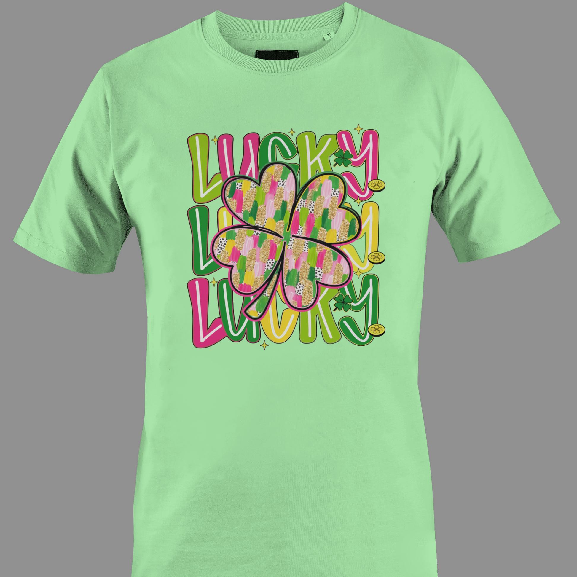 Light green t-shirt with colorful text 'Lucky' and a shamrocks