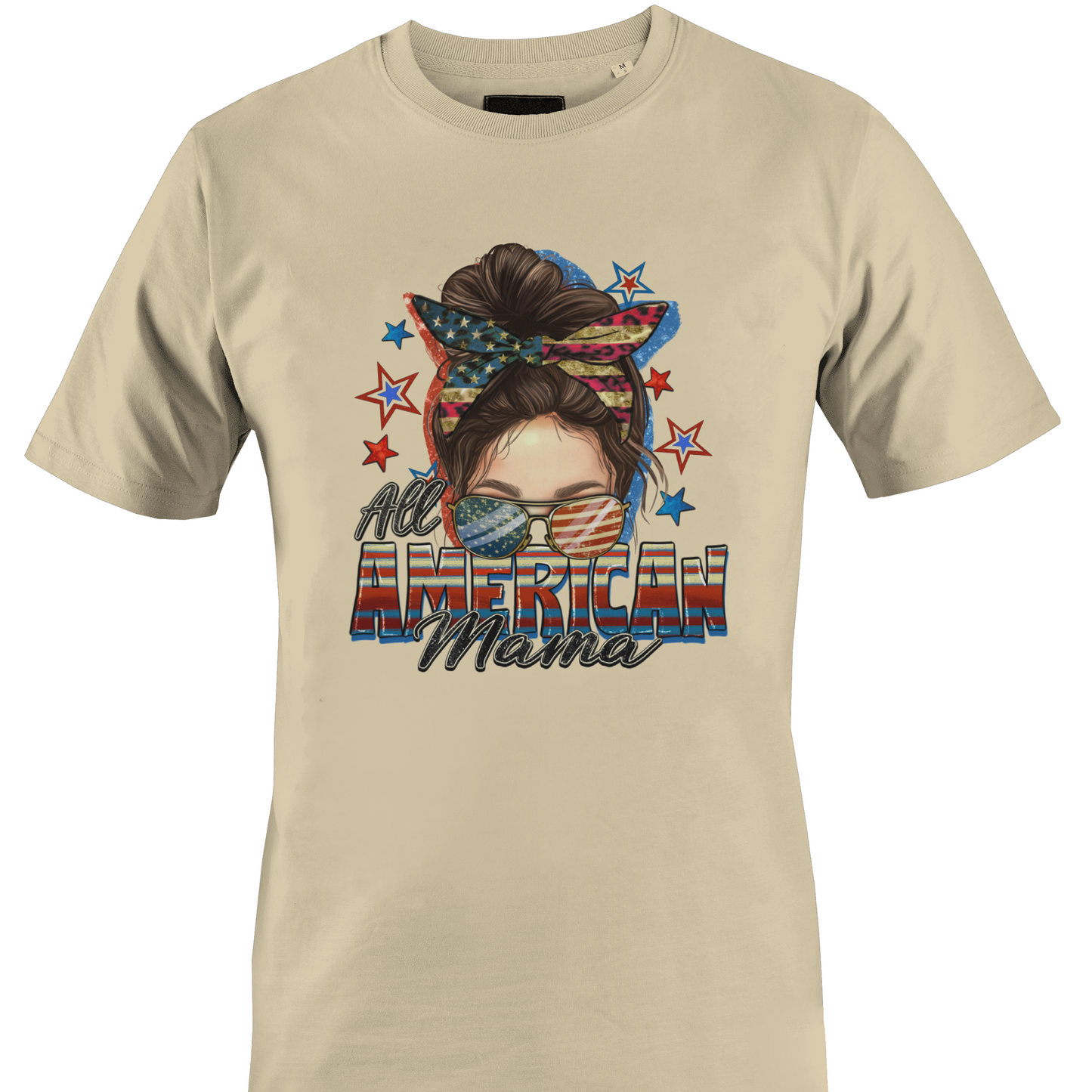 Beige t-shirt with a graphic design of a woman's face with an American flag headband and text 'All American Mama' 
