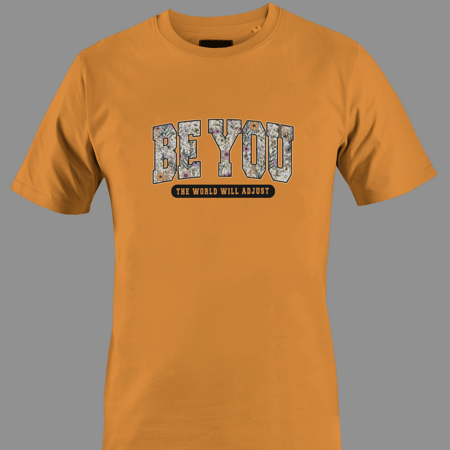 Orange t-shirt with 'BE YOU THE WORLD WILL ADJUST' text