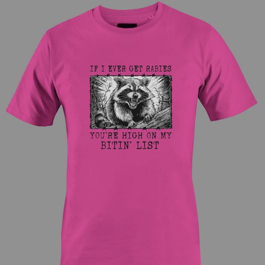 Dark pink t-shirt with a graphic of a raccoon and text rabies bite list 