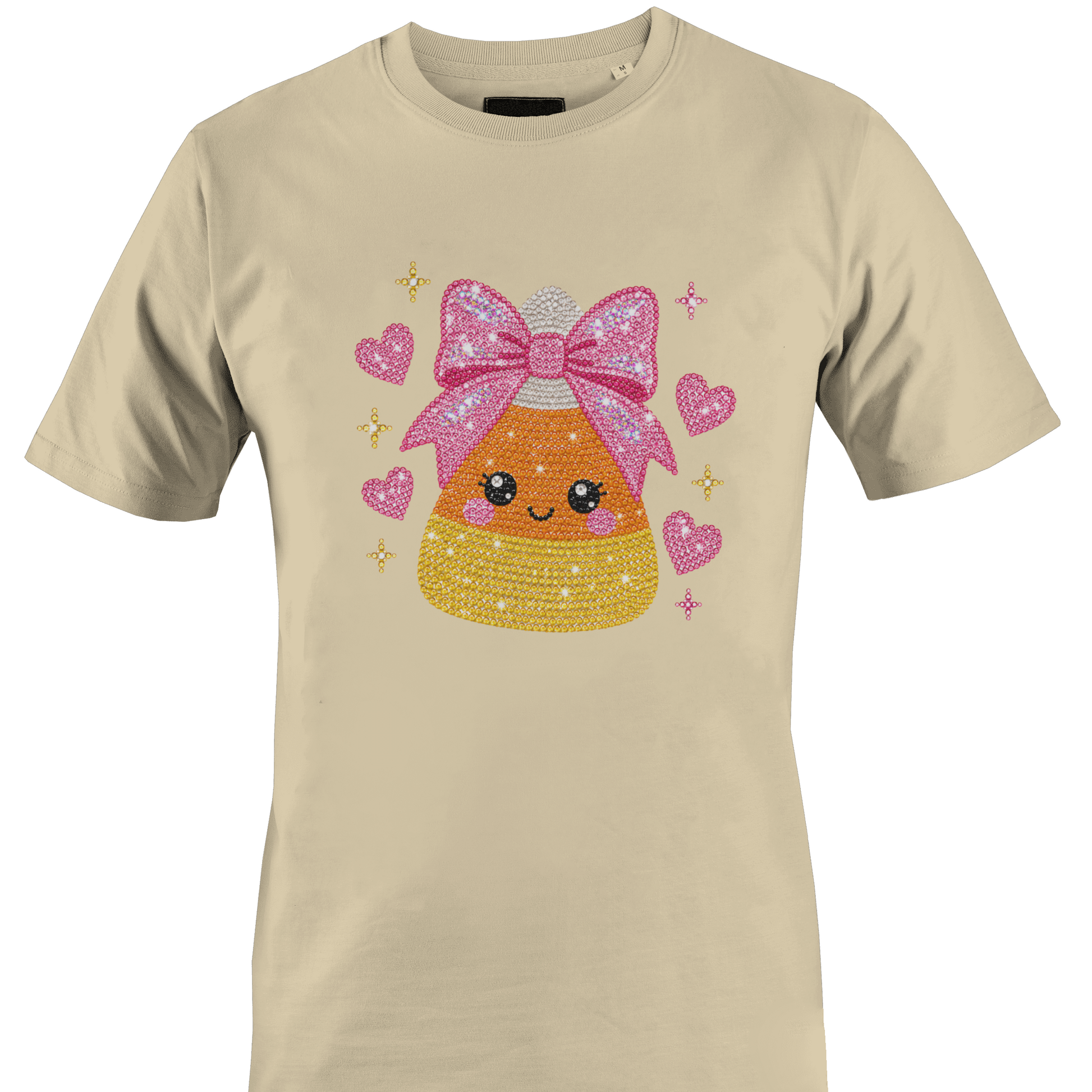 Tan t-shirt featuring a sparkly bling candy corn wearing a pink bow surrounded by hearts for Halloween by Monkey's Creations. 