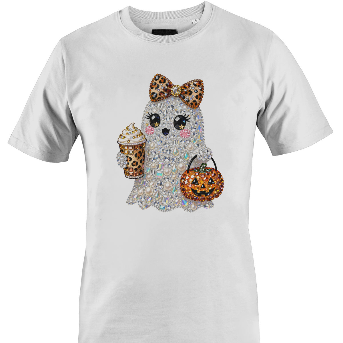 A white short-sleeve crewneck t-shirt featuring a graphic of a cute ghost character covered in rhinestones, holding a leopard-print pumpkin bucket and a leopard-print drink by Monkey's Creations.