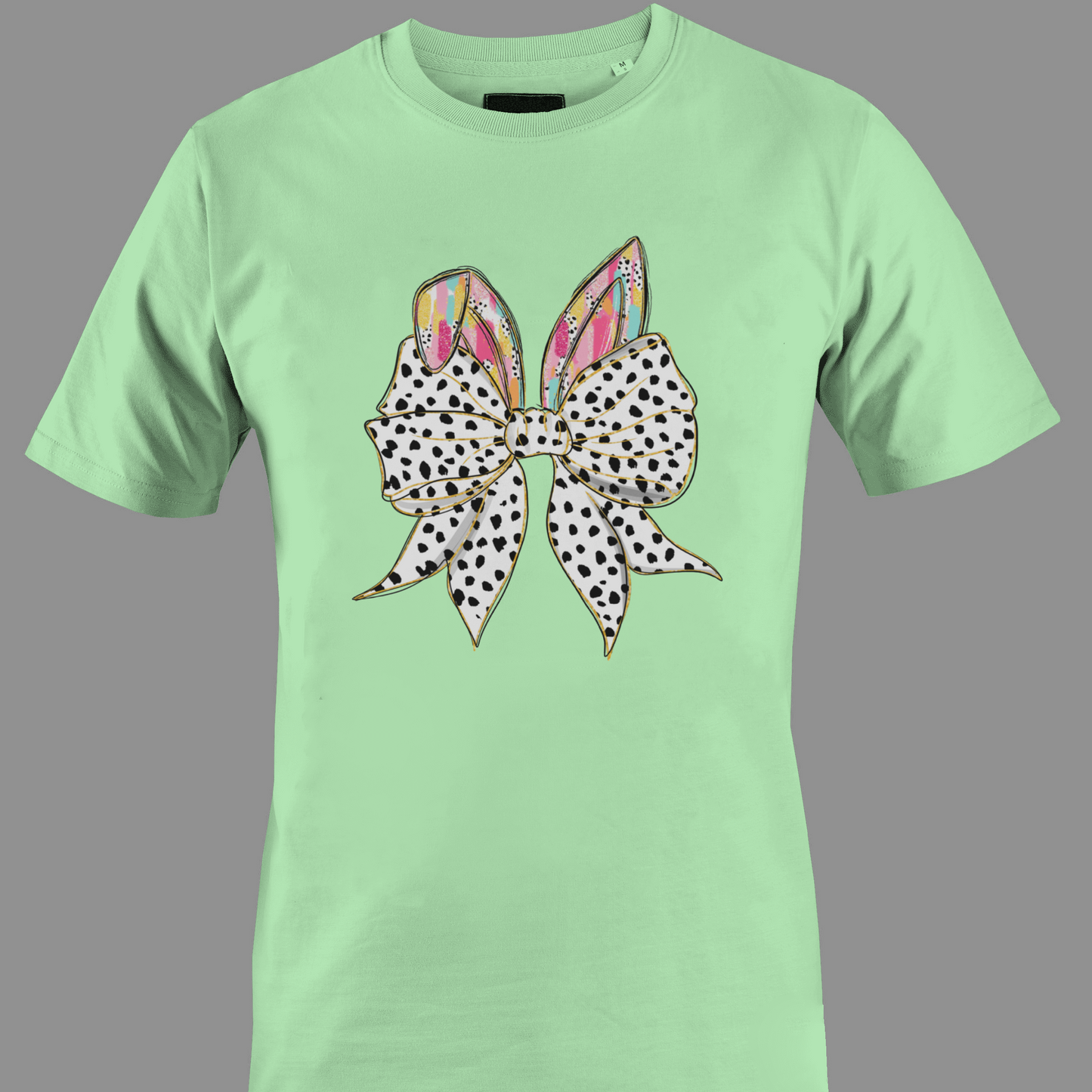 Light green t-shirt with a large polka dot bow and colorful rabbit ears