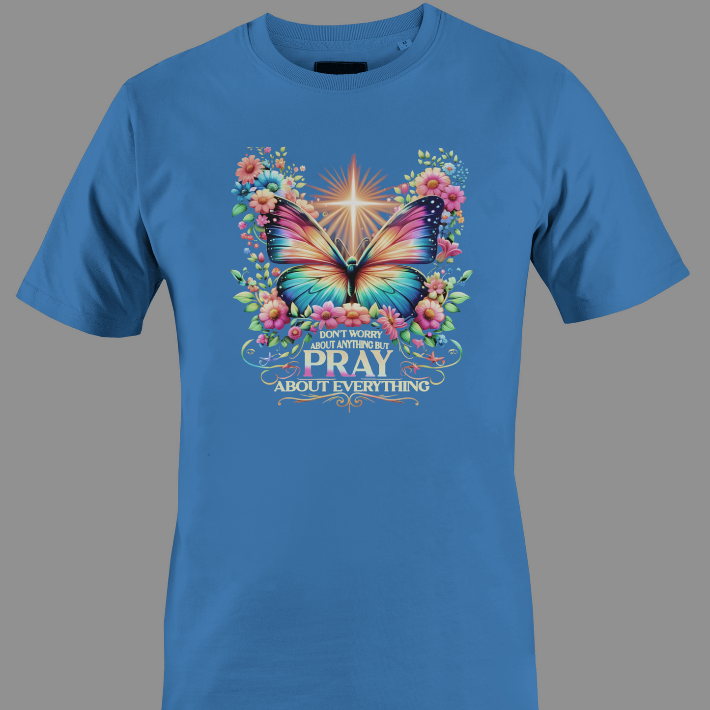 Blue t-shirt with a colorful butterfly and florals with text Pray 
