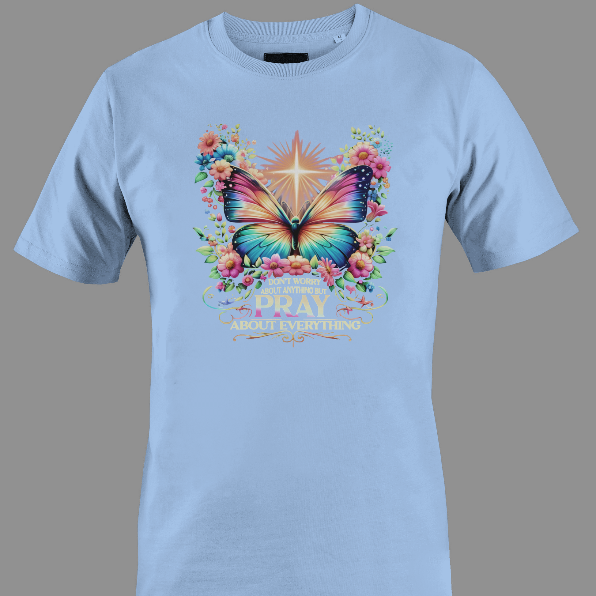 Light blue t-shirt with a colorful butterfly and florals with text Pray 