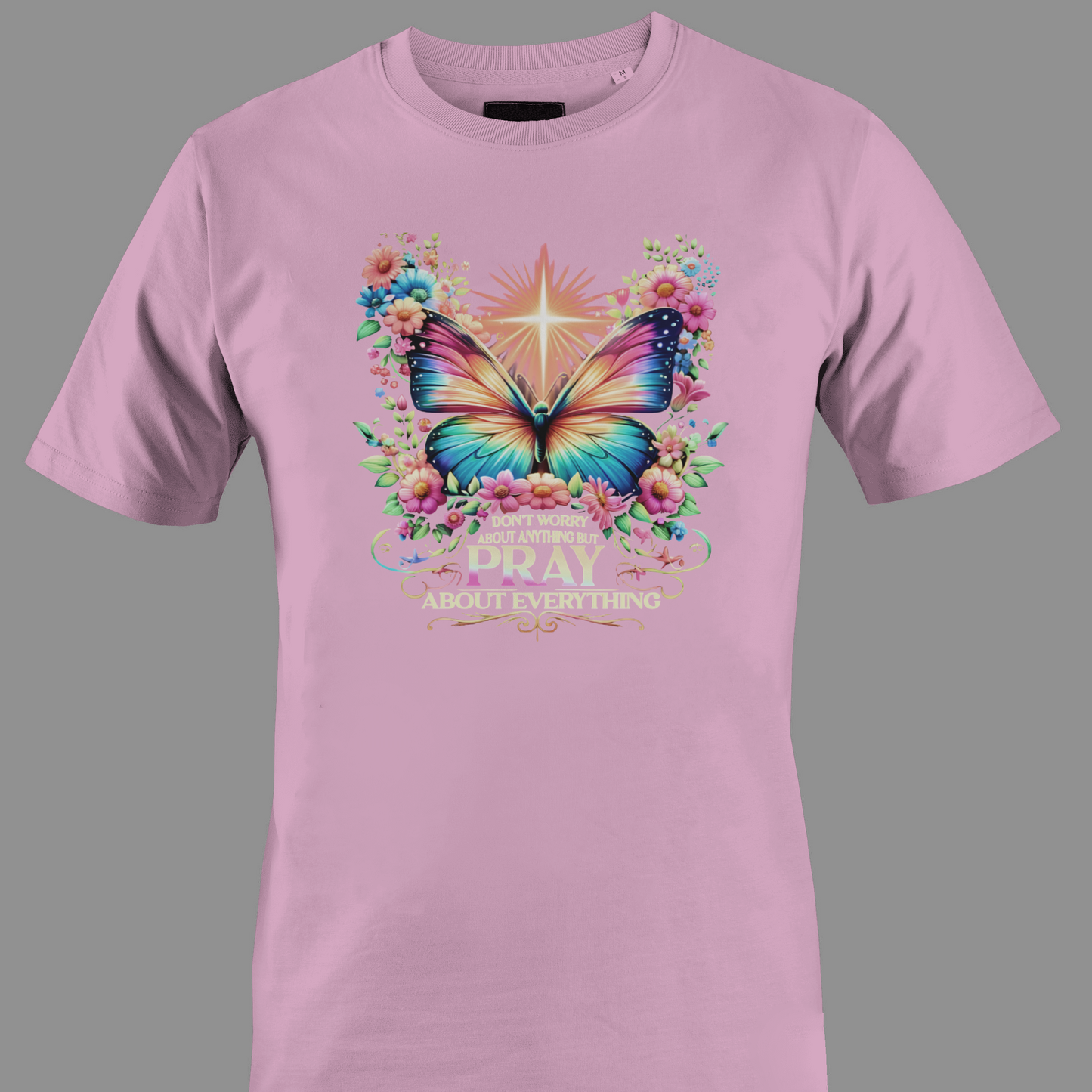 Light pink t-shirt with a colorful butterfly and florals with text Pray 