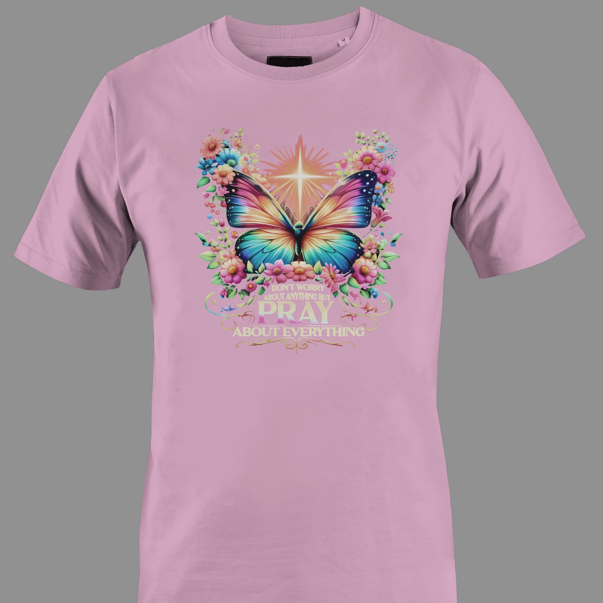 Light pink t-shirt with a colorful butterfly and florals with text Pray 