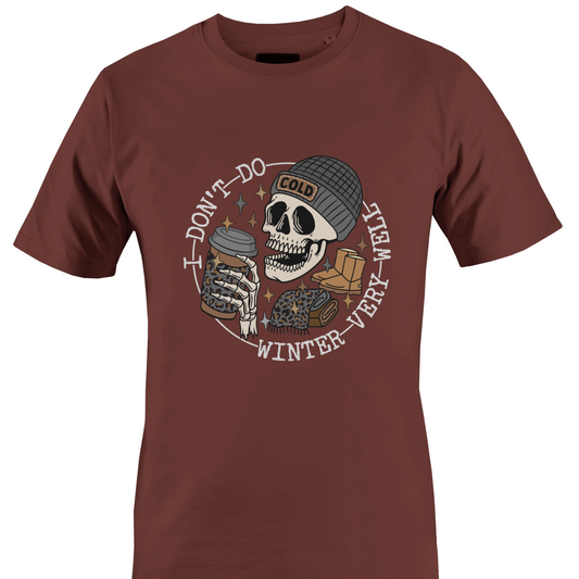 Brown t-shirt with a skeleton wearing a hat, ugg boots, a scarf and a coffee and the text "I don't do winter very well" by Monkey's Creations. 