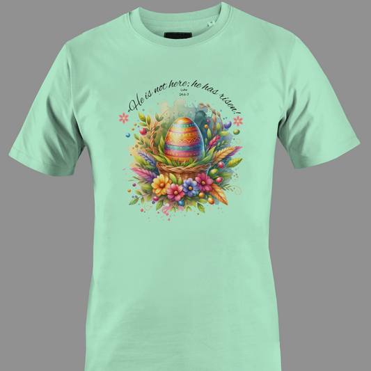Light green t-shirt with Easter egg in a basket with flowers and leaves, featuring a religious quote.