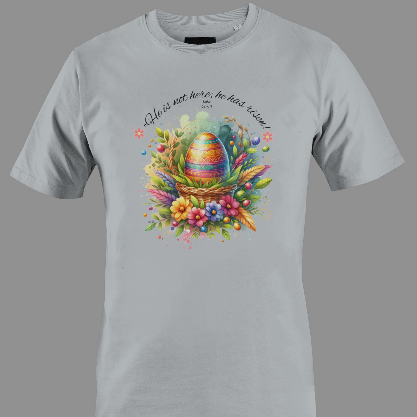 Light gray t-shirt with Easter egg in a basket with flowers and leaves, featuring a religious quote.
