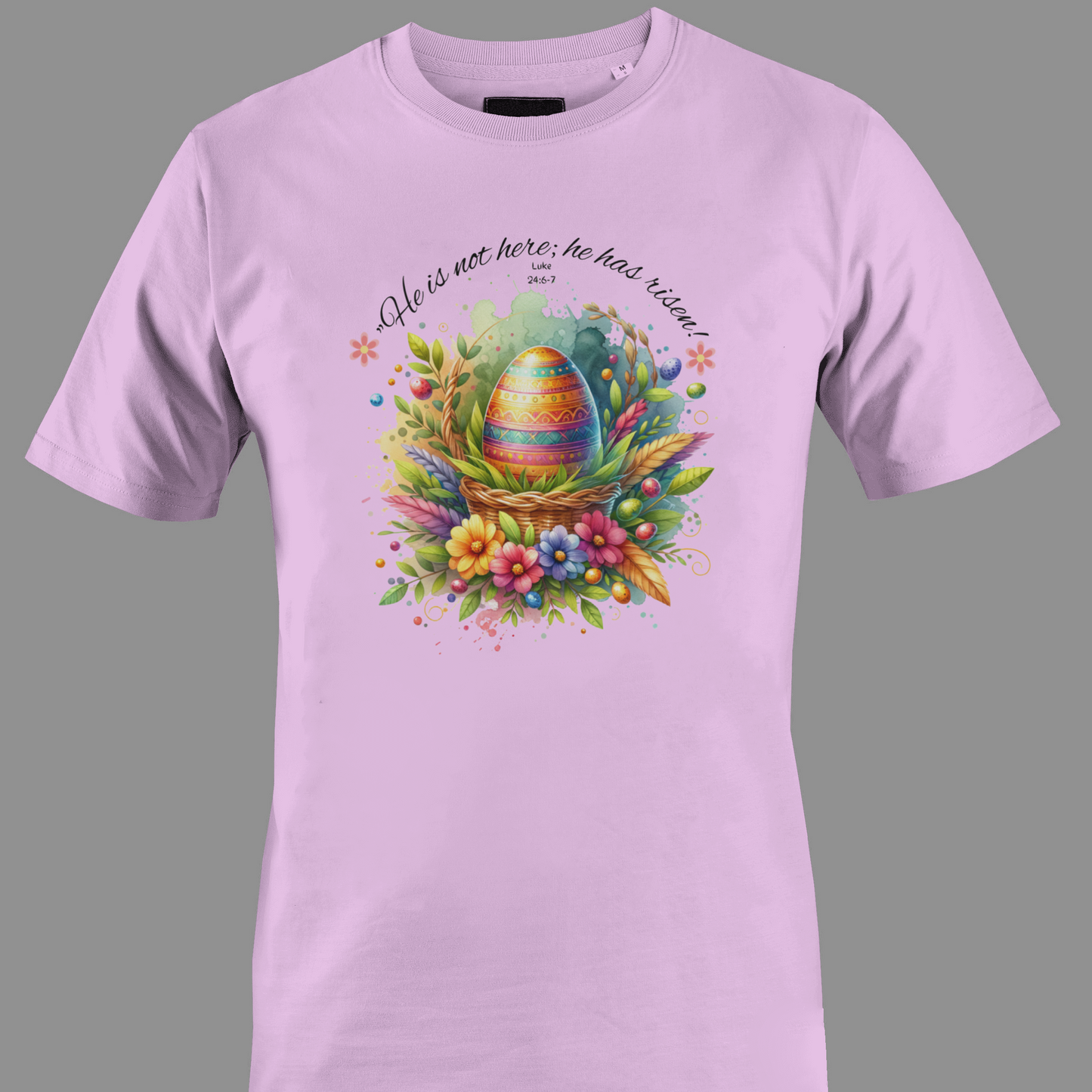 Light pink t-shirt with Easter egg in a basket with flowers and leaves, featuring a religious quote.