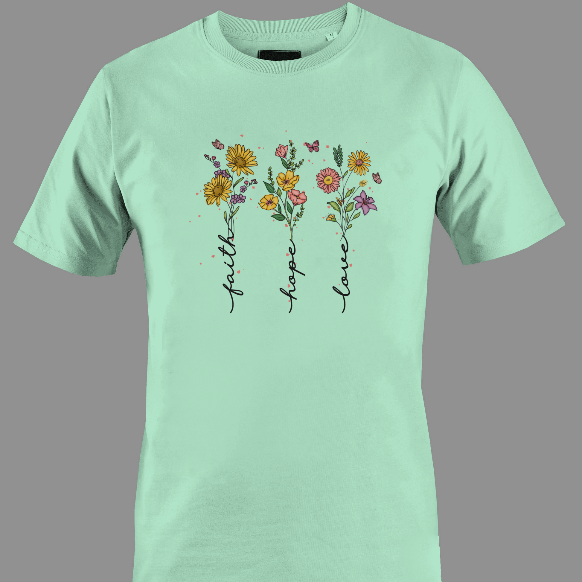 Light green t-shirt with flowers with stem text 'faith', 'hope', and 'love' 