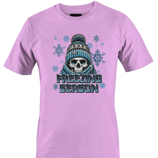 Pink t-shirt with a skull wearing a hat and scarf and the text "freezing season" by Monkey's Creations.