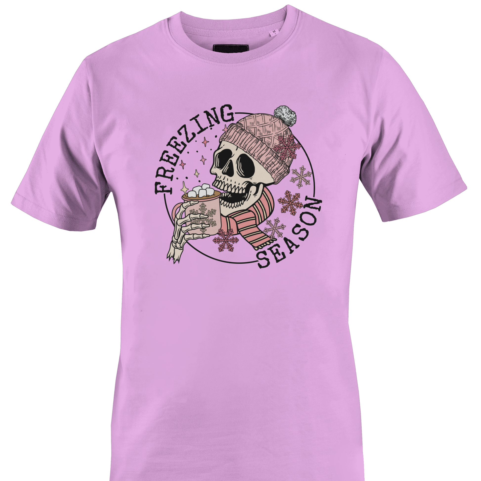 Pink  t-shirt with a skull wearing a hat and scarf with a hot chocolate and the text "freezing season" by Monkey's Creations.