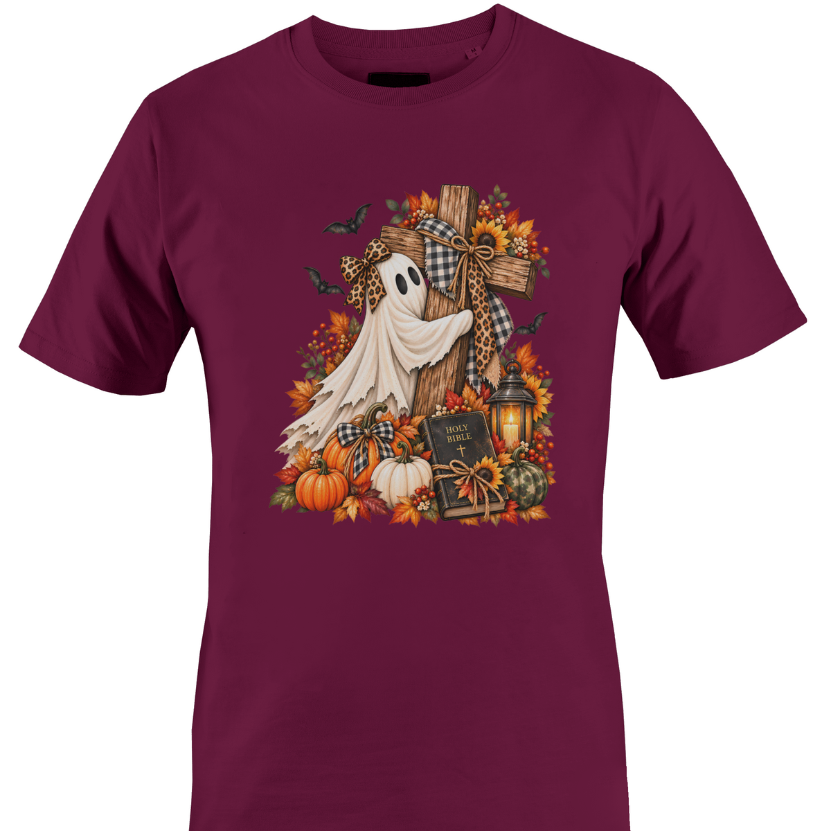 A burgundy crewneck t-shirt featuring a detailed autumn Halloween graphic with a white ghost draped over a wooden cross, surrounded by pumpkins, fall leaves, sunflowers, a lantern, and bats by Monkey's Creations.