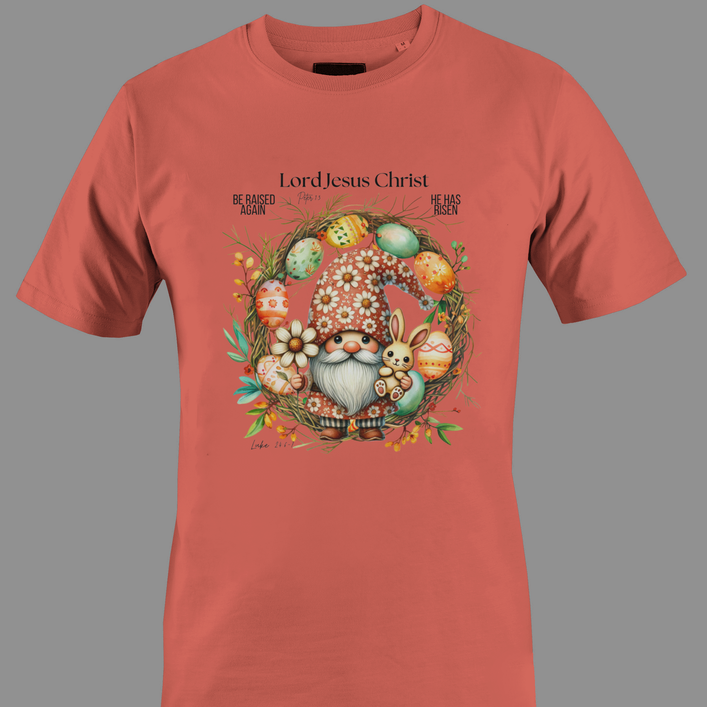 Coral t-shirt with an Easter gnome with a bunny, and Easter eggs surrounded by a wreath.