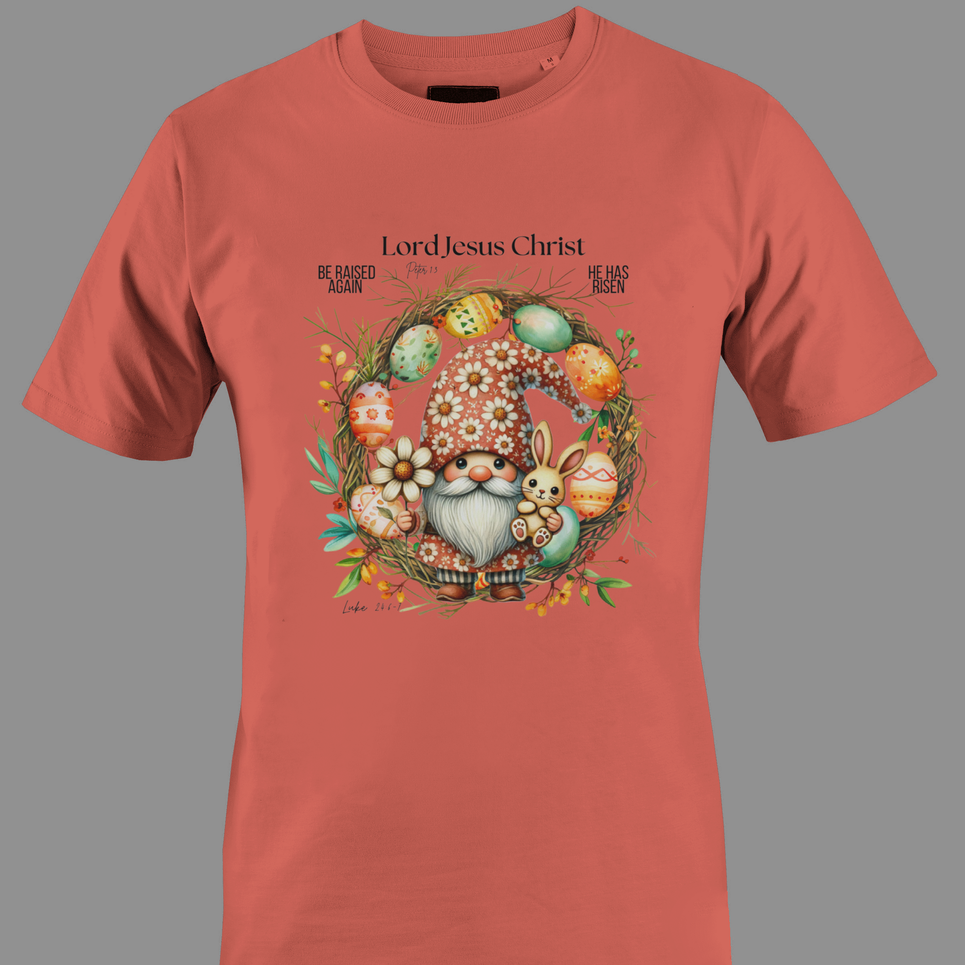 Coral t-shirt with an Easter gnome with a bunny, and Easter eggs surrounded by a wreath.