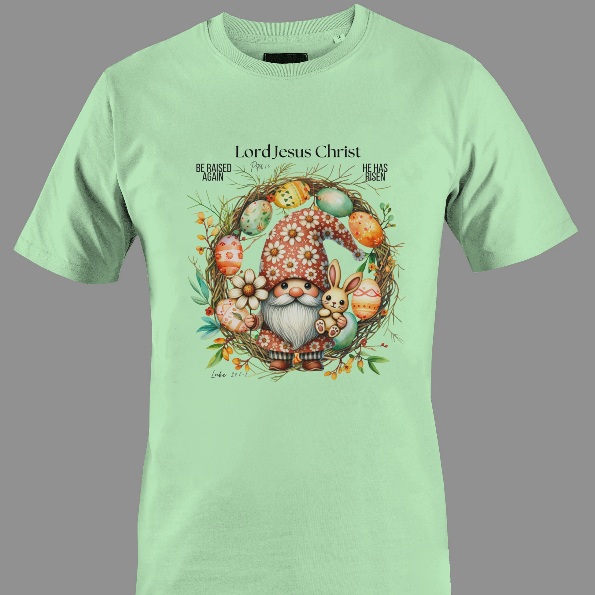 Light green t-shirt with an Easter gnome with a bunny, and Easter eggs surrounded by a wreath.