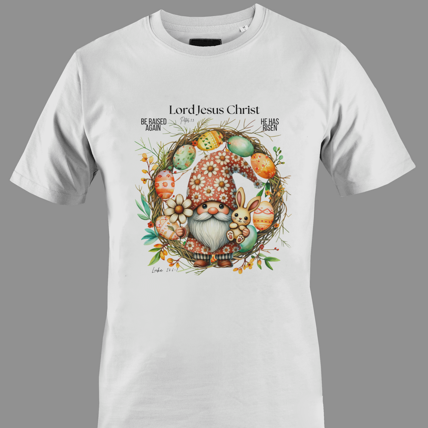 White t-shirt with an Easter gnome with a bunny, and Easter eggs surrounded by a wreath.