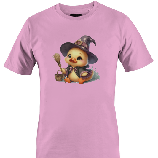 A light pink short-sleeve crewneck t-shirt featuring a cartoon graphic of a cute yellow duckling dressed as a witch in a pointed hat, holding a broom and a basket by Monkey's Creations.