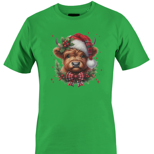 Green t-shirt with a highland cow wearing a plaid santa hat with holly berries and a plaid bow by Monkey's Creations. 