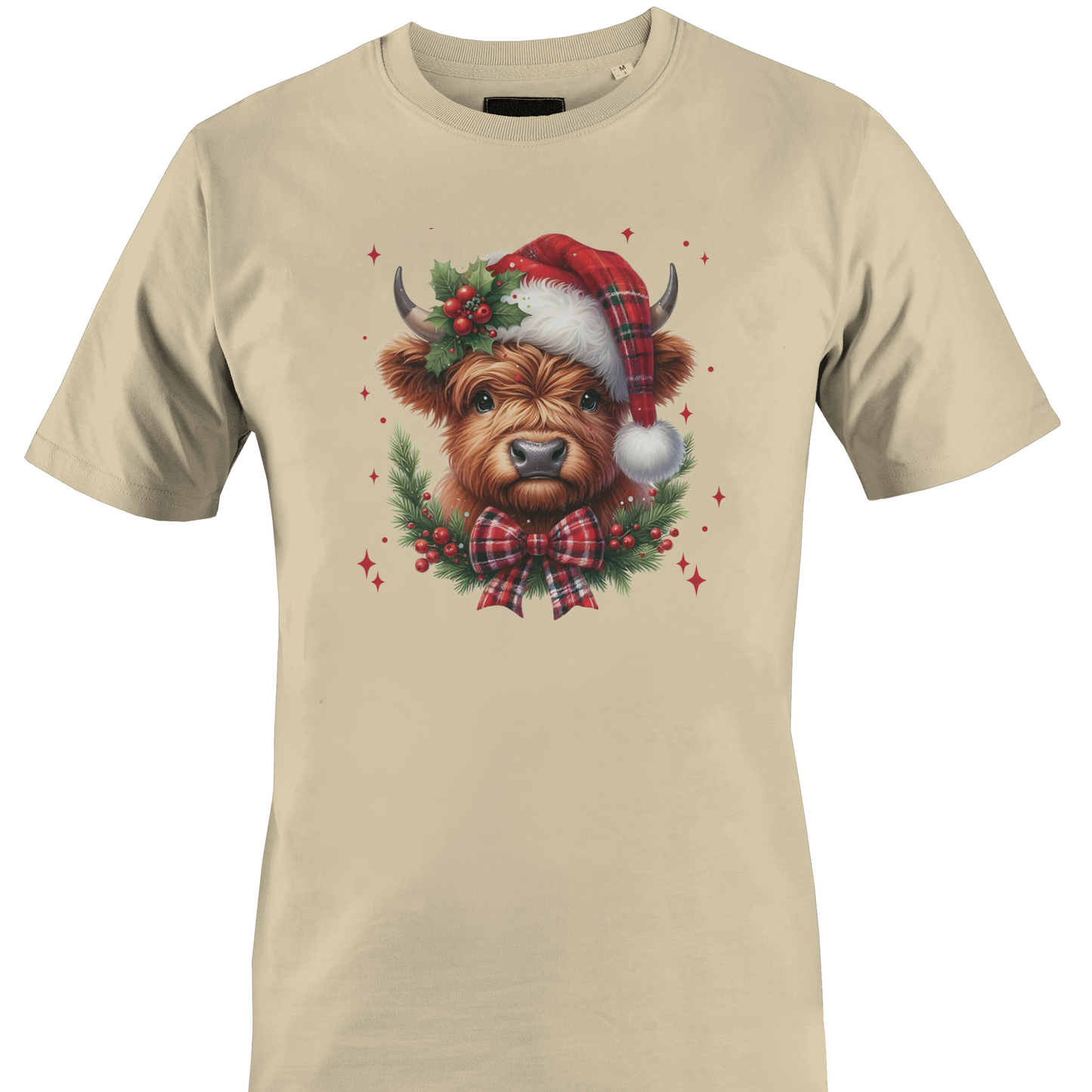 Tan t-shirt with a highland cow wearing a plaid santa hat with holly berries and a plaid bow by Monkey's Creations. 