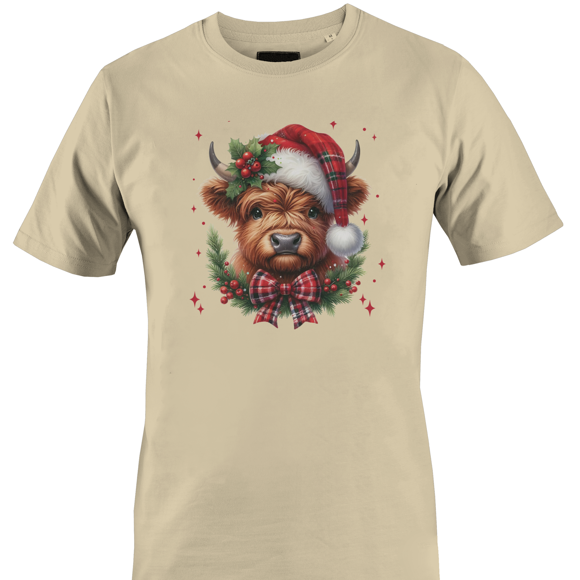 Tan t-shirt with a highland cow wearing a plaid santa hat with holly berries and a plaid bow by Monkey's Creations. 